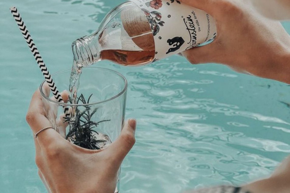 B&auml;rnstein wir in ein Glas eingeschenkt, Pool im Hintergrund