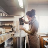 Bild anzeigen: Go&szlig;er Kochtopf, Frau p&uuml;rier mit einem gro&szlig;en P&uuml;rierstab